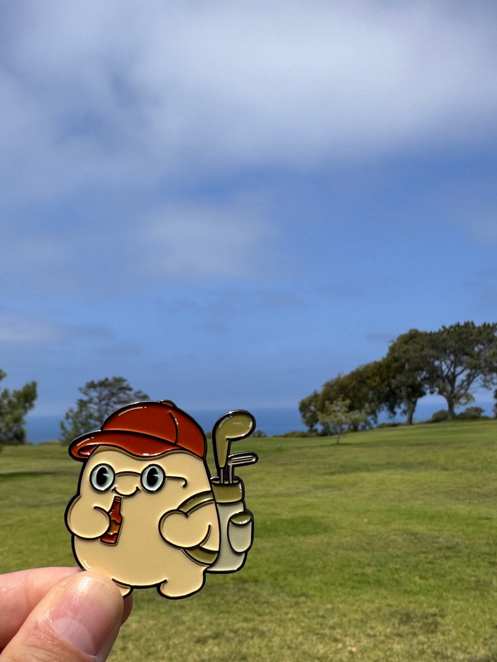 Cartoon character with a golf club held up against a scenic golf course background