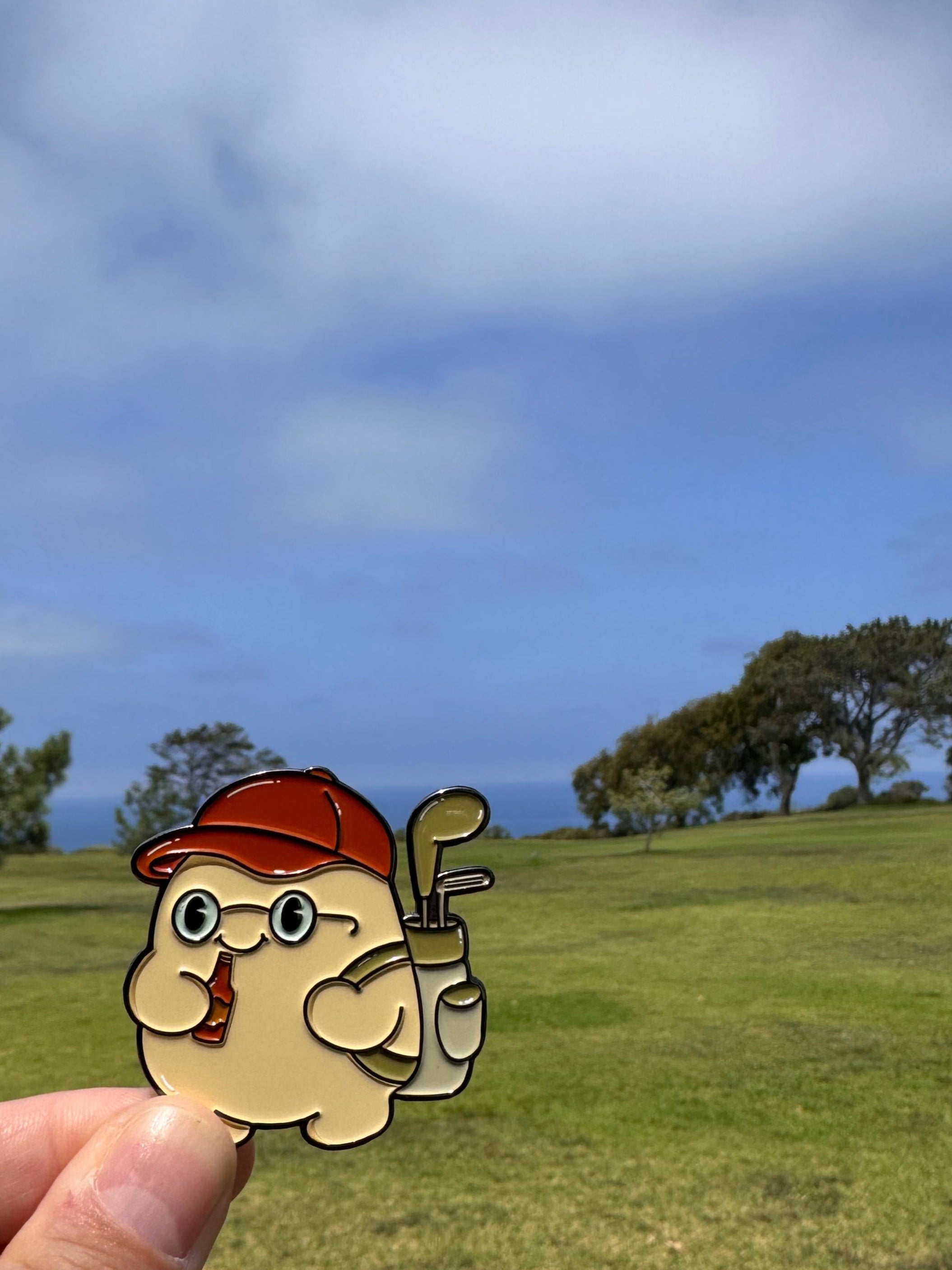 Cartoon character with a golf club held up against a scenic golf course background